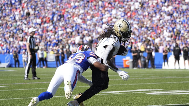 Sep 28, 2025; Orchard Park, New York, USA;  New Orleans Saints running back Alvin Kamara (41) is tackled by Buffalo Bills cornerback Dorian Strong (43) during the third quarter bat Highmark Stadium. Mandatory Credit: Gregory Fisher-Imagn Images