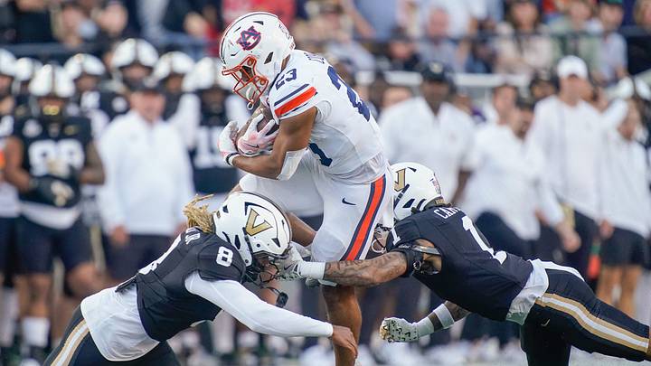 Auburn running back Jeremiah Cobb (23) is stopped by Vanderbilt safety CJ Heard (8) and safety Dontae Carter (1) during the second quarter at FirstBank Stadium in Nashville, Tenn., Saturday, Nov. 8, 2025. Auburn running back Jeremiah Cobb (23) is stopped by Vanderbilt safety CJ Heard (8) and safety Dontae Carter (1) during the second quarter at FirstBank Stadium in Nashville, Tenn., Saturday, Nov. 8, 2025.