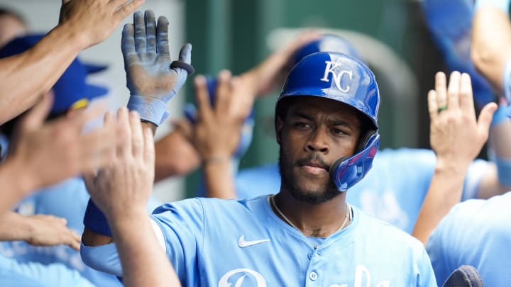 Jun 13, 2024; Kansas City, Missouri, USA; Kansas City Royals third baseman Maikel Garcia (11) is congratulated by teammates after scoring a run during the fourth inning against the New York Yankees at Kauffman Stadium. 