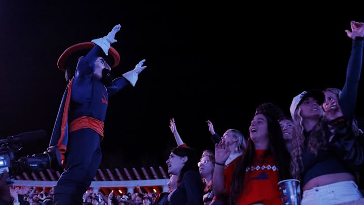 Nov 8, 2025; Charlottesville, Virginia, USA; Virginia Cavaliers mascot “Cav Man” sings with students in the stands during the second half against the Wake Forest Demon Deacons at Scott Stadium. Mandatory Credit: Amber Searls-Imagn Images
