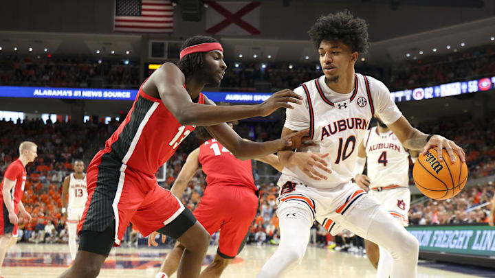 Feb 22, 2025; Auburn, Alabama, USA;  Georgia Bulldogs forward Dylan James (13) pressures Auburn Tigers guard Chad Baker-Mazara (10) during the second half at Neville Arena.  Mandatory Credit: John Reed-Imagn Images