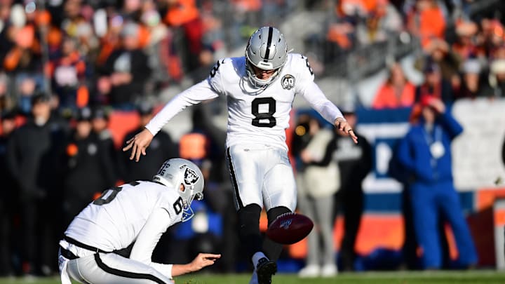 Dec 29, 2019; Denver, Colorado, USA; Oakland Raiders punter A.J. Cole (6) holds as kicker Daniel Carlson (8) kicks a field goal in the second quarter against the Denver Broncos at Empower Field at Mile High. Mandatory Credit: Ron Chenoy-Imagn Images