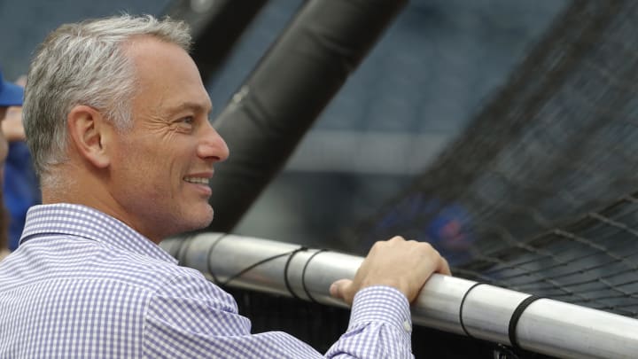 Chicago Cubs president Jed Hoyer looks on at the batting cage.