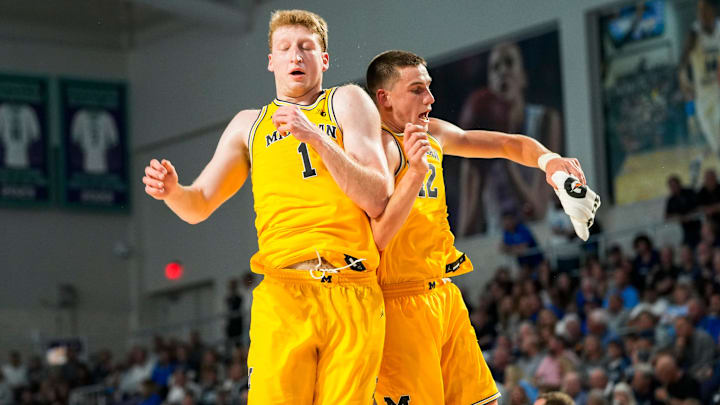 Michigan Wolverines center Danny Wolf (1) celebrates with forward Will Tschetter (42) during the first half of the Fort Myers Tip-Off Beach Division final against the Xavier Musketeers at Suncoast Credit Union Arena in Fort Myers, Fla., on Wednesday, Nov. 27, 2024.
