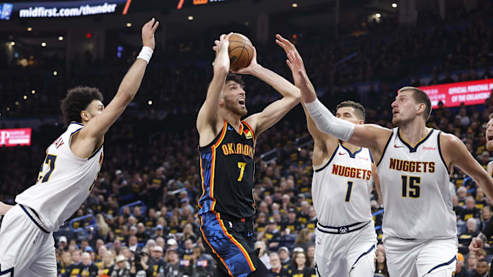 May 7, 2025; Oklahoma City, Oklahoma, USA;Oklahoma City Thunder forward Chet Holmgren (7) drives to the basket between Denver Nuggets guard Jamal Murray (27), forward Michael Porter Jr. (1) and center Nikola Jokic (15)  in the second half during game two of the second round for the 2025 NBA Playoffs at Paycom Center. Mandatory Credit: Alonzo Adams-Imagn Images