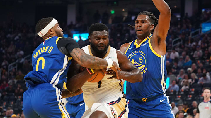  New Orleans Pelicans forward Zion Williamson (1) dribbles against Golden State Warriors guard Gary Payton II (0) and forward Kevon Looney (5) during the second quarter at Chase Center. Mandatory Credit: David Gonzales-Imagn Images