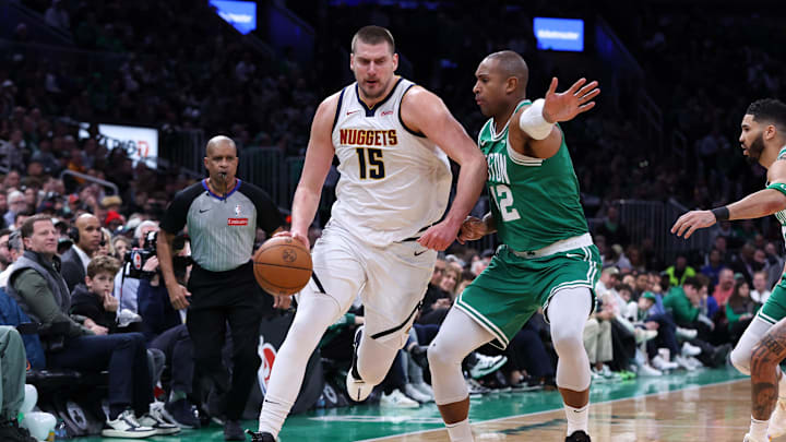 Mar 2, 2025; Boston, Massachusetts, USA; Denver Nuggets center Nikola Jokic (15) dribbles down the court defended by Boston Celtics center Al Horford (42) during the first half at TD Garden. Mandatory Credit: Paul Rutherford-Imagn Images