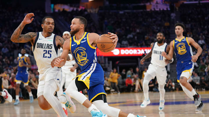 Apr 2, 2024; San Francisco, California, USA; Golden State Warriors guard Stephen Curry (30) dribbles the ball next to Dallas Mavericks forward P.J. Washington (25) in the third quarter at the Chase Center. Mandatory Credit: Cary Edmondson-Imagn Images
