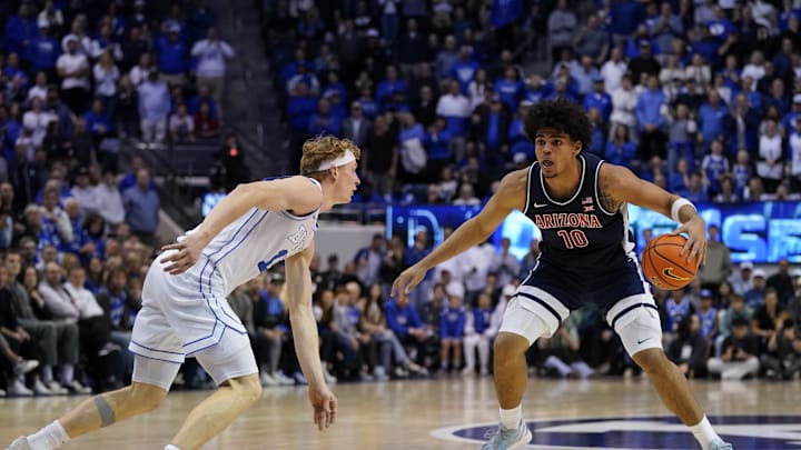 Jan 26, 2026; Provo, Utah, USA; BYU Cougars guard Richie Saunders (15) defends Arizona Wildcats forward Koa Peat (10) during the second half at Marriott Center. Mandatory Credit: Aaron Baker-Imagn Images 