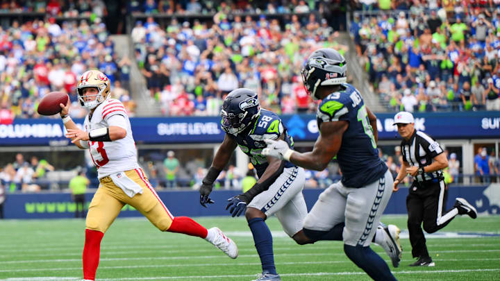 San Francisco 49ers quarterback Brock Purdy throws a touch down pass during the second half against Seattle Seahawks. San Francisco 49ers quarterback Brock Purdy throws a touch down pass during the second half against Seattle Seahawks.