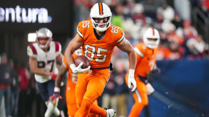 Dec 24, 2023; Denver, Colorado, USA; Denver Broncos tight end Lucas Krull (85) carries the ball in the second quarter against the New England Patriots at Empower Field at Mile High. Mandatory Credit: Ron Chenoy-USA TODAY Sports