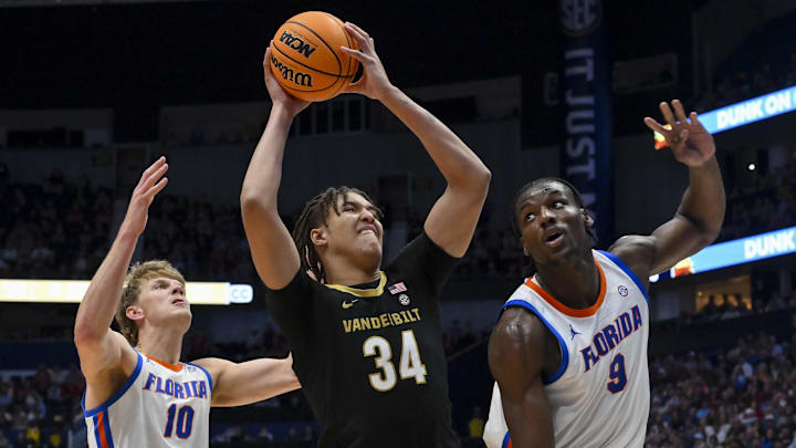 Mar 14, 2026; Nashville, TN, USA;  Vanderbilt Commodores center Jayden Leverett (34) and Florida Gators center Rueben Chinyelu (9) fight for the rebound during the second half at Bridgestone Arena. Mandatory Credit: Steve Roberts-Imagn Images