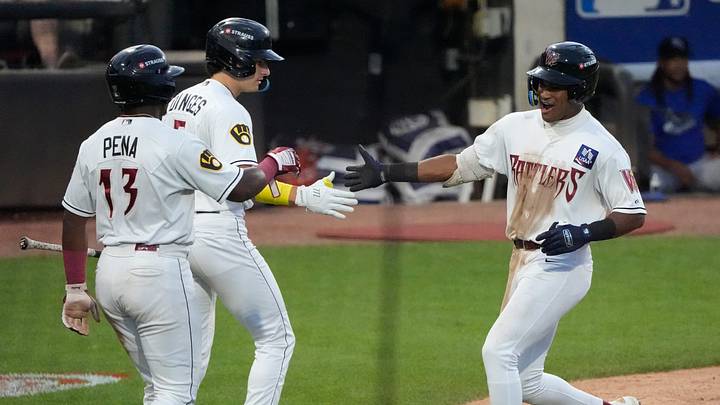 Wisconsin Timber Rattlers Braylon Payne (6) celebrates hitting a homerun with Luis Pena (13) and Marco Dinges (5) against the Quad Cities River Bandits during their baseball game Friday, July 17, 2026, at Neuroscience Group Field at Fox Cities Stadium in Grand Chute, Wisconsin. Wisconsin Timber Rattlers Braylon Payne (6) celebrates hitting a homerun with Luis Pena (13) and Marco Dinges (5) against the Quad Cities River Bandits during their baseball game Friday, July 17, 2026, at Neuroscience Group Field at Fox Cities Stadium in Grand Chute, Wisconsin.