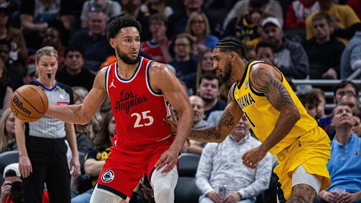 Feb 23, 2025; Indianapolis, Indiana, USA; LA Clippers guard Ben Simmons (25) dribbles the ball while Indiana Pacers forward Obi Toppin (1) defends in the second half at Gainbridge Fieldhouse. Mandatory Credit: Trevor Ruszkowski-Imagn Images