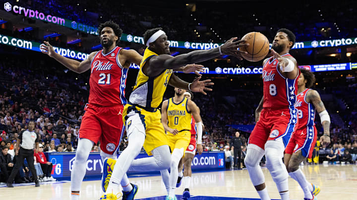 Dec 13, 2024; Philadelphia, Pennsylvania, USA; Indiana Pacers forward Pascal Siakam (43) passes the ball between Philadelphia 76ers forward Paul George (8) and center Joel Embiid (21) during the second quarter at Wells Fargo Center. Mandatory Credit: Bill Streicher-Imagn Images Dec 13, 2024; Philadelphia, Pennsylvania, USA; Indiana Pacers forward Pascal Siakam (43) passes the ball between Philadelphia 76ers forward Paul George (8) and center Joel Embiid (21) during the second quarter at Wells Fargo Center. Mandatory Credit: Bill Streicher-Imagn Images