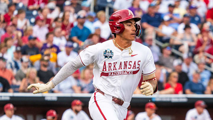 Jun 14, 2025; Omaha, Neb, USA; Arkansas Razorbacks shortstop Wehiwa Aloy (9) runs after hitting a single against the LSU Tigers during the fourth inning at Charles Schwab Field. Mandatory Credit: Dylan Widger-Imagn Images