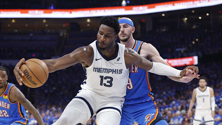 Memphis Grizzlies forward Jaren Jackson Jr. moves the ball against Oklahoma City Thunder guard Alex Caruso. Mandatory Credit: Alonzo Adams-Imagn Images
