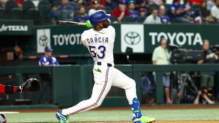 Aug 26, 2025; Arlington, Texas, USA; Texas Rangers right fielder Adolis Garcia (53) hits an rbi double during the first inning against the Los Angeles Angels at Globe Life Field. 
