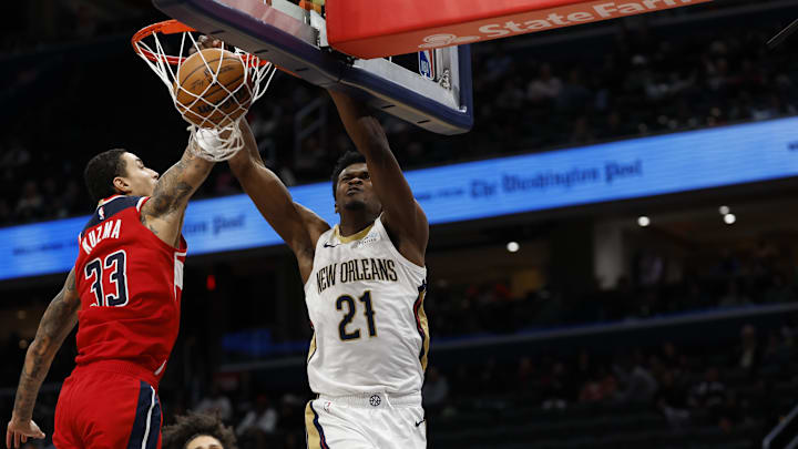 Jan 5, 2025; Washington, District of Columbia, USA; New Orleans Pelicans center Yves Missi (21) dunks the ball as Washington Wizards forward Kyle Kuzma (33) defends in the fourth quarter at Capital One Arena. Mandatory Credit: Geoff Burke-Imagn Images
