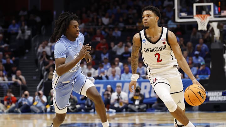 Mar 18, 2025; Dayton, OH, USA; San Diego State Aztecs guard Nick Boyd (2) dribbles the ball defended by North Carolina Tar Heels guard Ian Jackson (11) in the first half at UD Arena. 