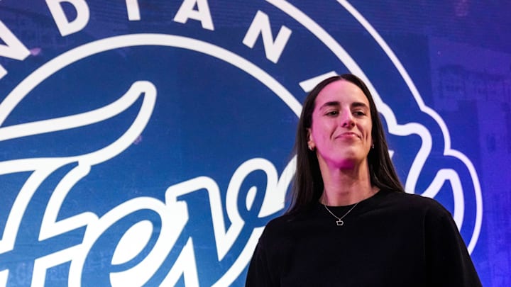 Indiana Fever guard Caitlin Clark (22) walks past the photo backdrop Wednesday, Aug. 28, 2024, during a game between the Indiana Fever and the Connecticut Sun at Gainbridge Fieldhouse in Indianapolis.