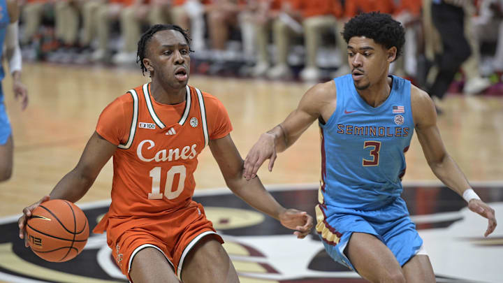 Feb 19, 2025; Tallahassee, Florida, USA; Miami Hurricanes guard Paul Djobet (10) drives past Florida State Seminoles guard Bostyn Holt (3) during the first half at Donald L. Tucker Center. Mandatory Credit: Melina Myers-Imagn Images Feb 19, 2025; Tallahassee, Florida, USA; Miami Hurricanes guard Paul Djobet (10) drives past Florida State Seminoles guard Bostyn Holt (3) during the first half at Donald L. Tucker Center. Mandatory Credit: Melina Myers-Imagn Images