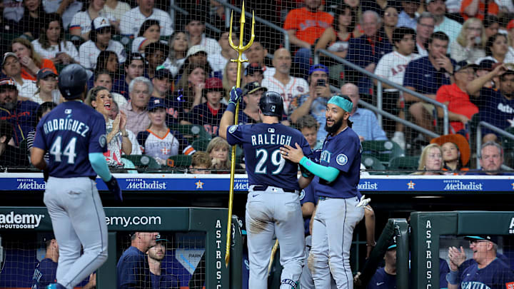 Seattle Mariners catcher Cal Raleigh (29) is congratulated by Seattle Mariners shortstop J.P. Crawford (3) after hitting a two-run home run against the Houston Astros during the seventh inning at Daikin Park on May 23.