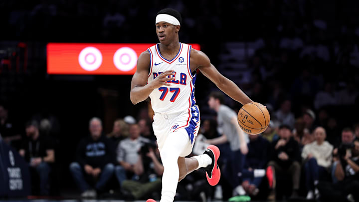 Feb 22, 2026; Minneapolis, Minnesota, USA; Philadelphia 76ers guard VJ Edgecombe (77) dribbles the ball up court against the Minnesota Timberwolves during the first half at Target Center.