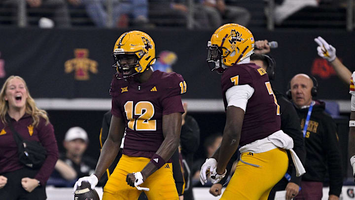 Dec 7, 2024; Arlington, TX, USA; Arizona State Sun Devils wide receiver Malik McClain (12) and tight end Chamon Metayer (7) celebrate during the first half against the Iowa State Cyclones at AT&T Stadium. Mandatory Credit: Jerome Miron-Imagn Images
