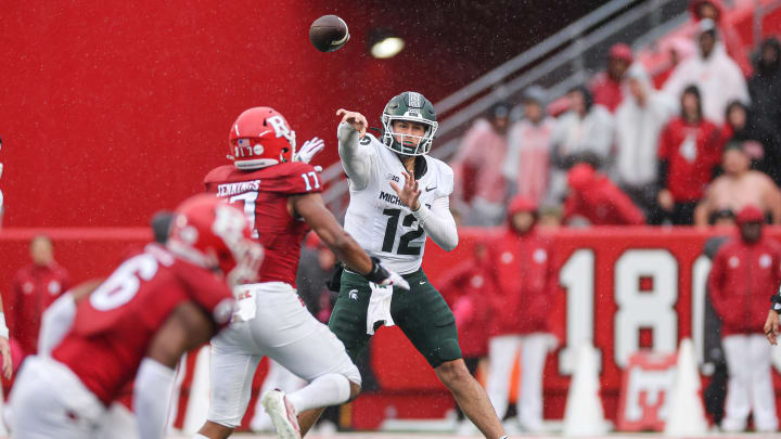 Oct 14, 2023; Piscataway, New Jersey, USA; Michigan State Spartans quarterback Katin Houser (12) throws the ball as Rutgers Scarlet Knights linebacker Deion Jennings (17) defends during the second half at SHI Stadium. Mandatory Credit: Vincent Carchietta-USA TODAY Sports