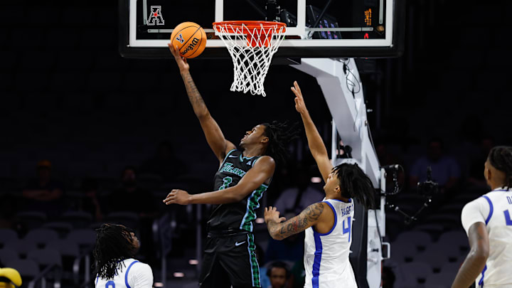 Mar 15, 2025; Fort Worth, TX, USA; Tulane Green Wave guard Kam Williams (3) scores a layup against Memphis Tigers guard PJ Haggerty (4) during the second half at Dickies Arena. Mandatory Credit: Chris Jones-Imagn Images Mar 15, 2025; Fort Worth, TX, USA; Tulane Green Wave guard Kam Williams (3) scores a layup against Memphis Tigers guard PJ Haggerty (4) during the second half at Dickies Arena. Mandatory Credit: Chris Jones-Imagn Images