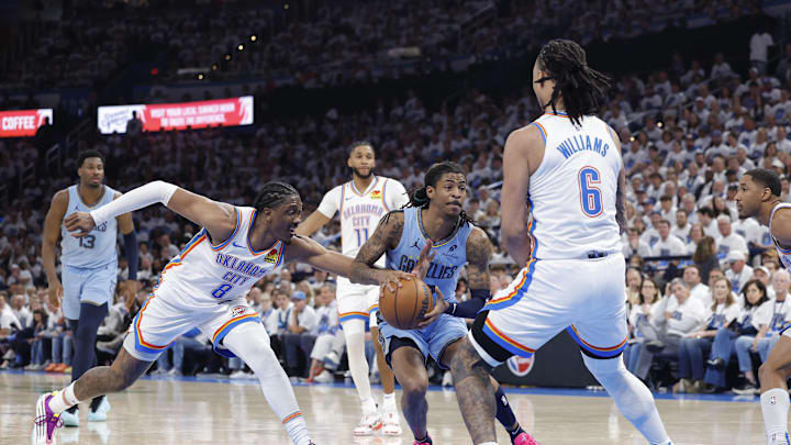 Apr 20, 2025; Oklahoma City, Oklahoma, USA; Memphis Grizzlies guard Ja Morant (12) drives to the basket between Oklahoma City Thunder forward Jalen Williams (8) and forward Jaylin Williams (6) during the second half at Paycom Center. Mandatory Credit: Alonzo Adams-Imagn Images