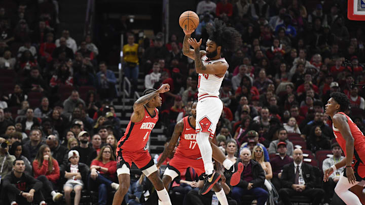 Nov 17, 2024; Chicago, Illinois, USA;  Chicago Bulls guard Coby White (0) passes the ball away from Houston Rockets guard Jalen Green (4) during the first half at United Center. Mandatory Credit: Matt Marton-Imagn Images
