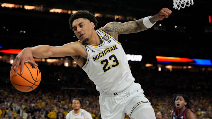 Michigan forward Yaxel Lendeborg (23) looks to keep the ball in bounds during the second half of the NCAA national championship game against Connecticut at Lucas Oil Stadium in Indianapolis on Monday, April 6, 2026.