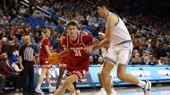 Jan 21, 2025; Los Angeles, California, USA;  Wisconsin Badgers forward Nolan Winter (31) dribbles against UCLA Bruins center Aday Mara (15) during the second half at Pauley Pavilion presented by Wescom. Mandatory Credit: Kiyoshi Mio-Imagn Images