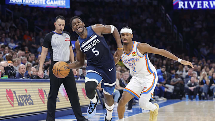 Feb 24, 2025; Oklahoma City, Oklahoma, USA; Minnesota Timberwolves guard Anthony Edwards (5) works to keep the ball inbounds as Oklahoma City Thunder guard Shai Gilgeous-Alexander (2) defends during the second half at Paycom Center. Mandatory Credit: Alonzo Adams-Imagn Images