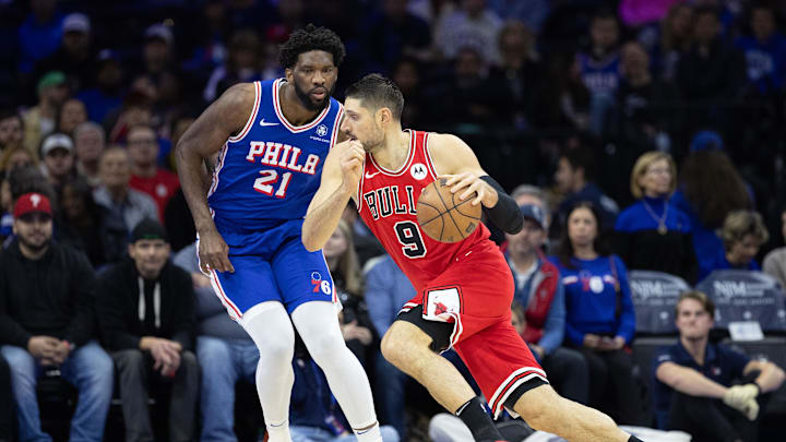 Chicago Bulls center Nikola Vucevic (9) drives against Philadelphia 76ers center Joel Embiid (21) during the first quarter at Wells Fargo Center. Mandatory Credit: Bill Streicher-Imagn Images