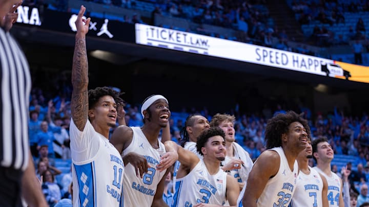 Dec 22, 2025; Chapel Hill, North Carolina, USA; North Carolina Tar Heels forward Jonathan Powell (11), forward Caleb Wilson (8), and guard Derek Dixon (3) react during the second half against the East Carolina Pirates at Dean E. Smith Center. Mandatory Credit: Scott Kinser-Imagn Images