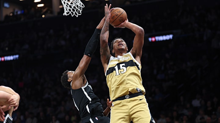 Apr 5, 2026; Brooklyn, New York, USA; Washington Wizards forward Julian Reese (15) drives to the basket against Brooklyn Nets guard Drake Powell (4) during the first quarter at Barclays Center. Mandatory Credit: Vincent Carchietta-Imagn Images