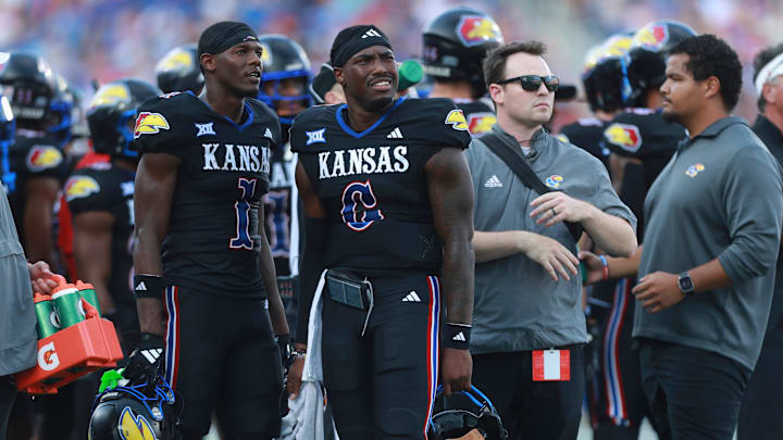 Kansas Jayhawks quarterback Jalon Daniels (6) watches a replay alongside Kansas Jayhawks wide receiver Emmanuel Henderson Jr. (1) during the first half of the game against West Virginia Mountaineers at David Booth Kansas Memorial Stadium on Sept. 20, 2025.