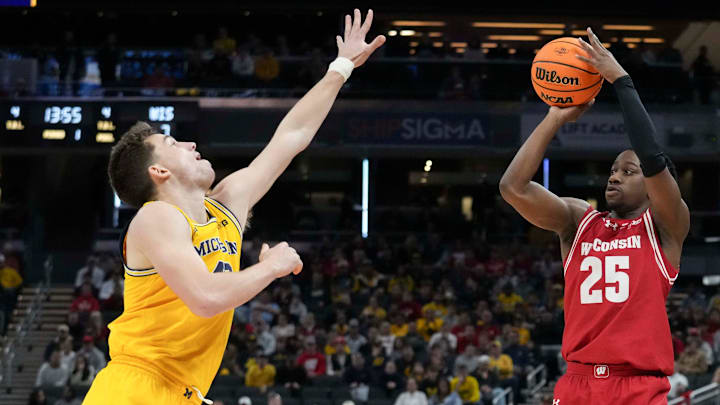 Michigan Wolverines forward Will Tschetter (42) guards Wisconsin Badgers guard John Blackwell (25) as he shoots during the first half of the 2025 TIAA Big Ten Men’s Basketball Tournament final game on Sunday, March 16, 2025, at Gainbridge Fieldhouse in Indianapolis.