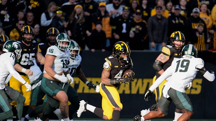 Iowa Hawkeyes running back Jaziun Patterson (4) carries the ball against the Michigan State Spartans Nov. 22, 2025 at Kinnick Stadium in Iowa City, Iowa.