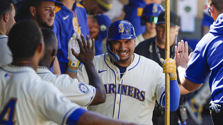 Aug 10, 2025; Seattle, Washington, USA; Seattle Mariners first baseman Josh Naylor (12) celebrates in the dugout after hitting a solo-home run against the Tampa Bay Rays during the seventh inning at T-Mobile Park. Mandatory Credit: Joe Nicholson-Imagn Images Aug 10, 2025; Seattle, Washington, USA; Seattle Mariners first baseman Josh Naylor (12) celebrates in the dugout after hitting a solo-home run against the Tampa Bay Rays during the seventh inning at T-Mobile Park. Mandatory Credit: Joe Nicholson-Imagn Images