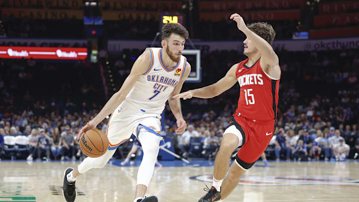 Oct 9, 2024; Oklahoma City, Oklahoma, USA; Oklahoma City Thunder forward Chet Holmgren (7) drives around Houston Rockets guard Reed Sheppard (15) during the second quarter at Paycom Center. Mandatory Credit: Alonzo Adams-Imagn Images