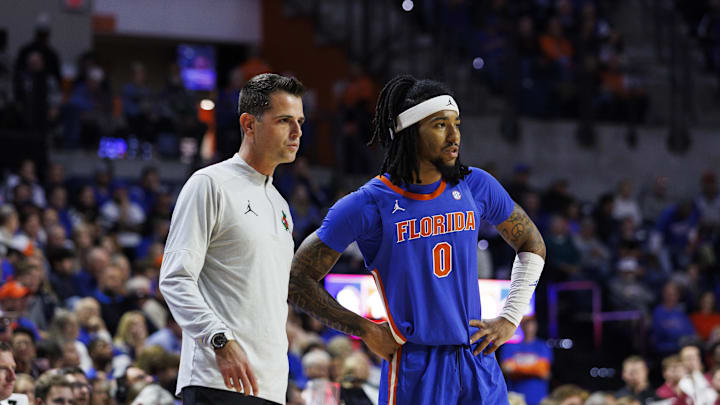 Nov 11, 2025; Gainesville, Florida, USA; Florida Gators head coach Todd Golden and guard Boogie Fland (0) speak during the first half against Florida State Seminoles at Exactech Arena at the Stephen C. O'Connell Center. Mandatory Credit: Morgan Tencza-Imagn Images