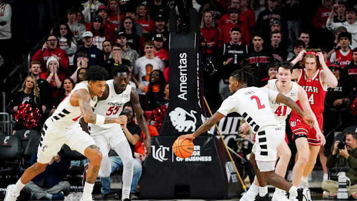 Cincinnati Bearcats guard Jizzle James (2) grabs a loose ball in the first half of a NCAA men’s basketball game between the Cincinnati Bearcats and Utah Utes, Tuesday, Feb. 11, 2025, at Fifth Third Arena in Cincinnati.