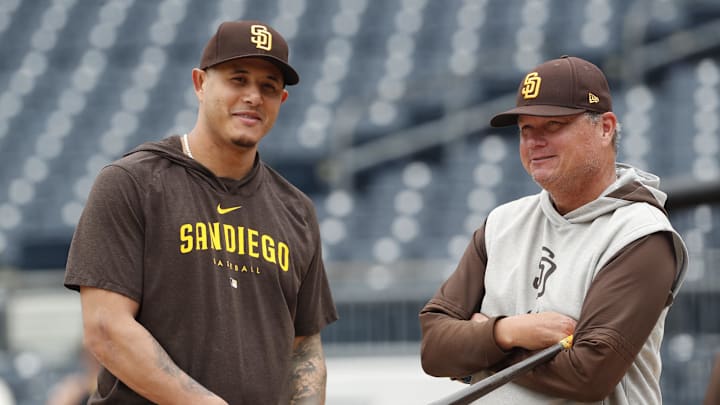 Aug 7, 2024; Pittsburgh, Pennsylvania, USA;  San Diego Padres third baseman Manny Machado (13) and manager Mike Shildt (8) talk at the batting cage before a game against the Pittsburgh Pirates at PNC Park. Mandatory Credit: Charles LeClaire-Imagn Images