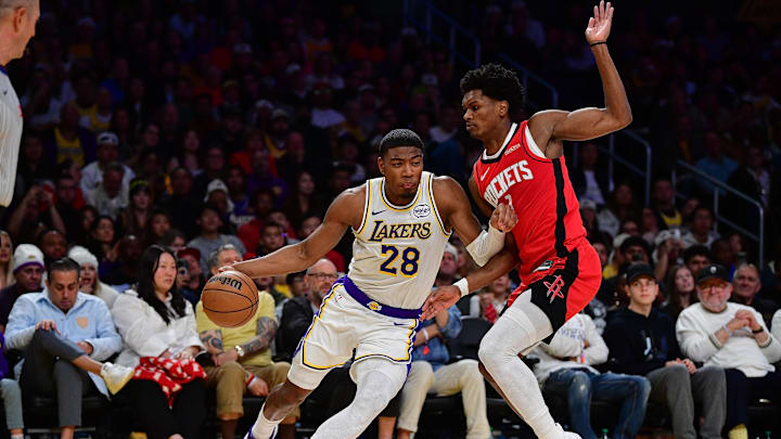 Dec 25, 2025; Los Angeles, California, USA; Los Angeles Lakers forward Rui Hachimura (28) moves to the basket against Houston Rockets guard Amen Thompson (1) during the first half at Crypto.com Arena. Mandatory Credit: Gary A. Vasquez-Imagn Images
