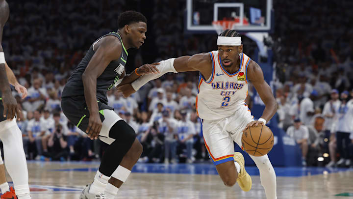 May 20, 2025; Oklahoma City, Oklahoma, USA; Oklahoma City Thunder guard Shai Gilgeous-Alexander (2) drives against Minnesota Timberwolves guard Anthony Edwards (5) in the fourth quarter during game one of the western conference finals for the 2025 NBA Playoffs at Paycom Center. Mandatory Credit: Alonzo Adams-Imagn Images