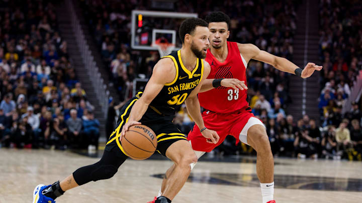 Golden State Warriors guard Stephen Curry (30) drives past Portland Trail Blazers forward Toumani Camara (33)  during the second half at Chase Center. Mandatory Credit: John Hefti-Imagn Images
